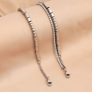 Macro view of silver Morse code bead chain and tennis chain bracelet with lobster clasp