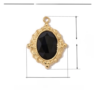 Detail view of 19mm gold stainless steel floral pendant with oval black natural stone