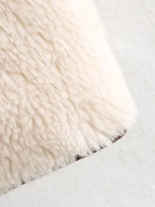 Detailed macro view of soft cream faux fur material for fleece long sleeve jacket