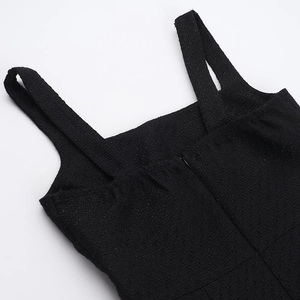 Detail of black tweed dress showing shoulder straps and hidden back zipper