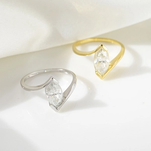 Minimalist 18k gold and silver marquise cut moissanite ring set in high gloss finish