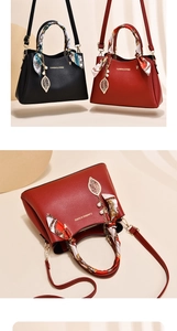 Detail of red and black bridal tote bags with silk scarves and gold leaf pendants