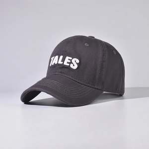 Close-up of deep gray cotton baseball cap featuring white TALES 3D embroidery detail