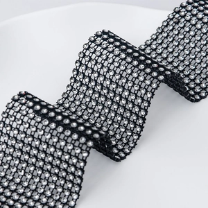 Detailed macro of flexible black mesh ribbon with 24 rows of sparkling crystals for DIY