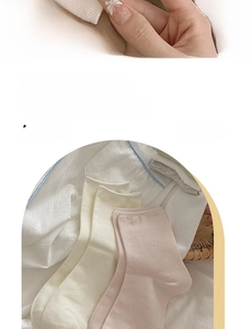 Close-up of soft knitted combed cotton socks in cream and pale pink Morandi tones