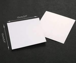 Detail shot of white kraft paper place cards showing 10x10cm size and texture