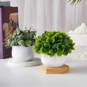 Two artificial green plants in white ceramic pots for modern desktop home decoration