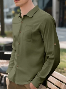 Detail of olive green linen shirt featuring waffle texture and wood-style buttons