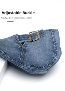 Close-up of adjustable brass metal buckle on blue denim newsboy cap with precise stitching