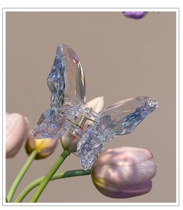 Close-up of translucent butterfly hair claw with iridescent finish on tulip flower