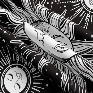 Macro view of sun and moon printed fabric showing fine texture and draped folds