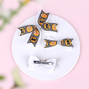 Halloween bow hair clips set featuring black cat and skull patterns on orange stripes