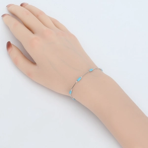 Detail of 925 sterling silver chain bracelet with rectangular blue turquoise stones