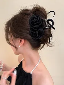 Elegant large black fabric rose hair claw clip with silk ribbons on model back view