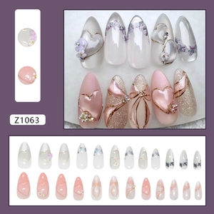 French cat-eye press-on nails with purple floral bows and heart gems in 24-piece set
