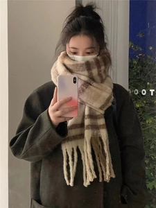 Mirror selfie showing the drape of a thick beige and brown plaid scarf with fringe