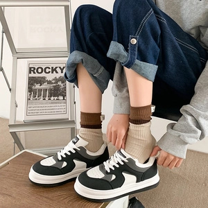 Detail of black and white platform sneakers paired with stylish neutral crew socks