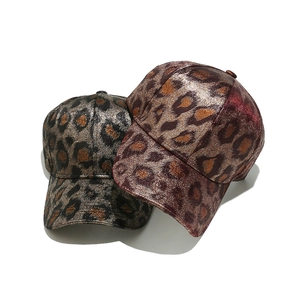 Metallic leopard print baseball caps in bronze and red-brown with shiny finish