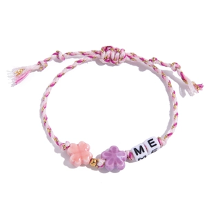Detailed shot of handmade woven bracelet with ceramic flowers and ME letter beads