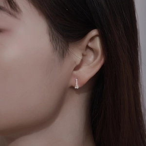 Close-up of minimalist sterling silver bar stud earrings with sparkling crystals