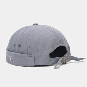 Detail of adjustable metal buckle and N embroidery on grey canvas miki hat