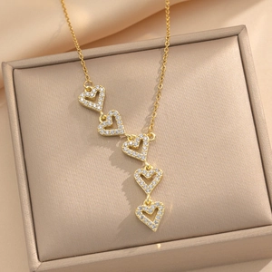 Luxurious gold titanium steel necklace featuring five hollow heart pendants with crystals