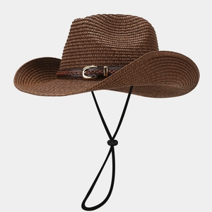 Detail of straw cowboy hat with leather braided band and gold horseshoe buckle