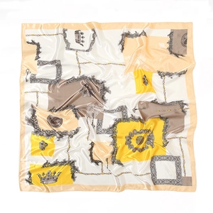 Detailed close-up of Baroque silk scarf featuring chain, crown, and coin patterns