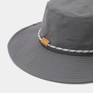 Detail of waterproof grey hiking hat showing decorative stitching and leather adjustment