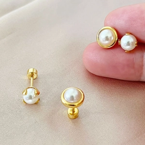 Elegant white pearl stud earrings with gold plating and secure flat screw back closures