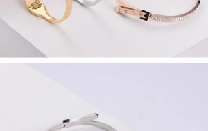 Detail of rhinestone inlay and clasp on gold and silver stainless steel bangles
