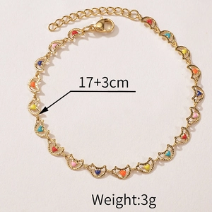 Detail view of gold flower bracelet with colorful heart enamel charms and extension chain