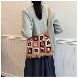 Detailed view of camel knitted crochet tote bag with colorful granny square patterns