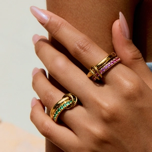 Chic gold-plated titanium steel rings with green and pink zircon in a knotted design