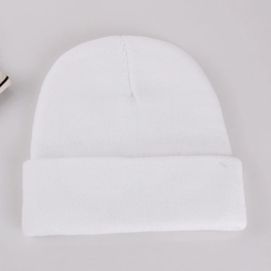 Detailed close-up of pure white knitted beanie showing soft fabric texture and ribbed cuff