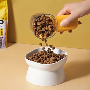 Multifunctional pet food measuring spoon with ergonomic yellow handle and white feeding bowl
