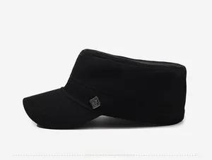 Side view of black cotton flat top military cap with a metal badge decorative detail