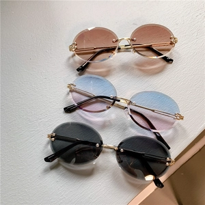 Trois paires de lunettes de soleil ovales sans monture avec verres dégradés dorés