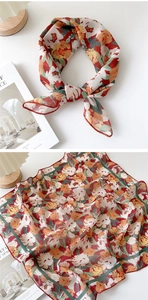Detail of floral cotton linen scarf showing delicate red hem and soft breathable fabric