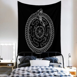 Detail of bohemian black and white ouroboros tapestry with stars on home wall