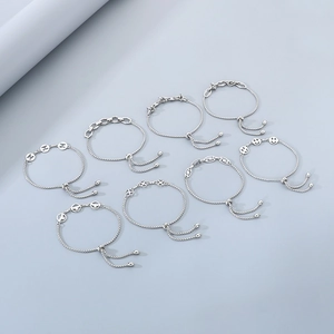 Selection of silver adjustable bracelets with charms like smiley faces and clovers