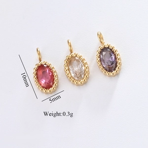 Detailed view of mini gold stainless steel oval charms with inlaid zircons and dimensions