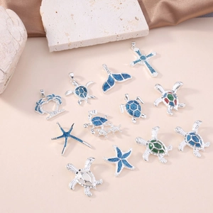 Collection of silver ocean necklaces with blue opal sea turtle, starfish and whale tail pendants
