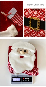 Close-up of red knit Christmas decor with Santa applique and weight display at 194g