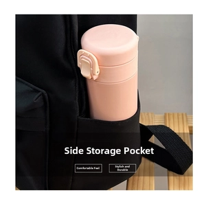 Detailed close-up showing the side storage pocket of the black backpack with a water bottle