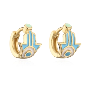 Detail of gold-plated Hamsa hand earrings with blue evil eye enamel charms