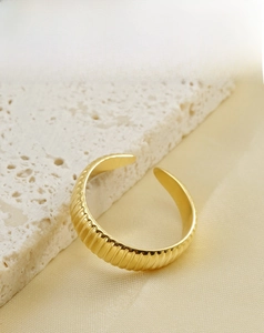 Detailed view of 18K gold plated stainless steel open ring with vertical ribbed texture