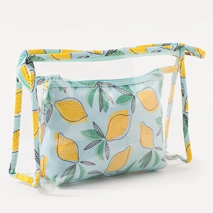 Close-up of clear PVC cosmetic bag with lemon print and matching blue fabric pouch