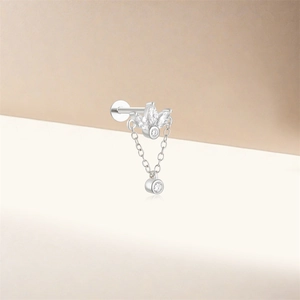 Macro detail of silver lotus earring with marquise zircon stones and dangling chain