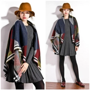Detail of color-block plaid shawl with fringe tassels and soft faux cashmere texture